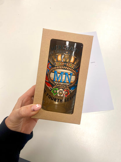 Pint glass, sailor tattoo Merchant Navy badge and swallows